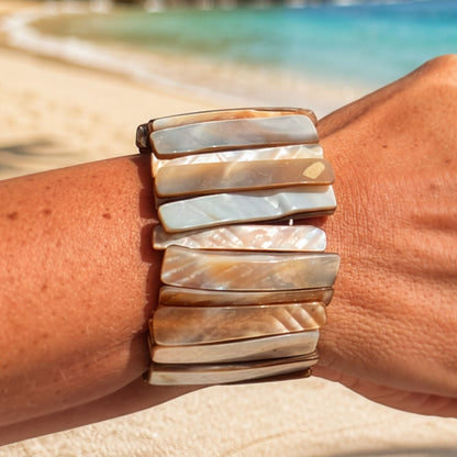 Parelmoer armband Sand Shell met langwerpige beige en parelmoerkleurige schakels gedragen op het strand