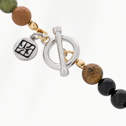 Detail van de zilverkleurige roestvrijstalen togglesluiting van de Forest Green kralenketting voor heren, met ronde bedel en goudkleurige accenten.