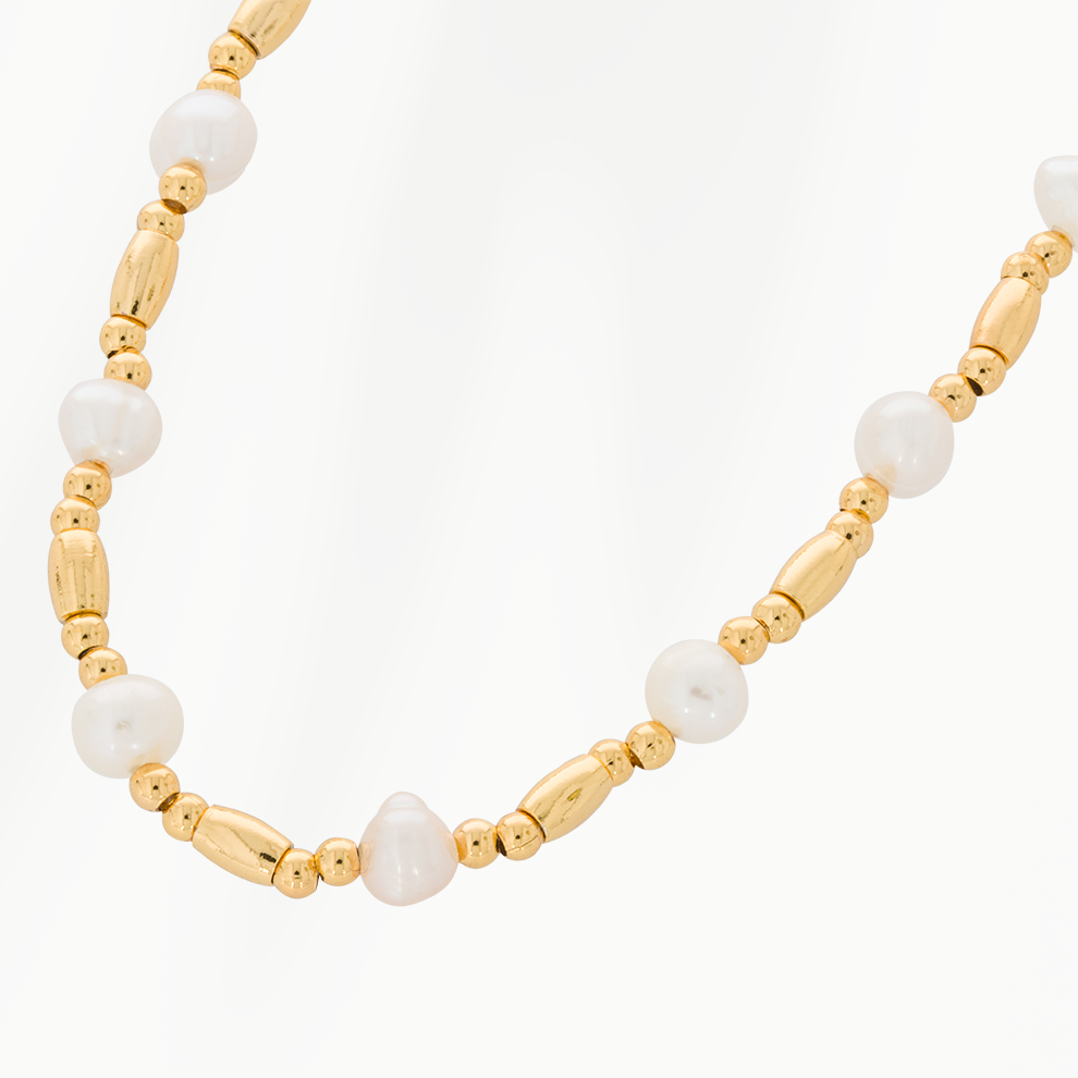 Close-up van de Ripple Chain parelketting van SummerGear met echte witte parels, langwerpige goudvergulde kralen en kleine ronde goudkleurige details.